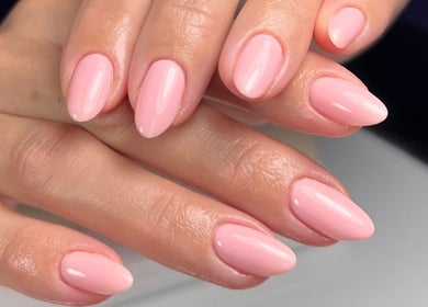 Glossy pink manicure at Solara Beauty, Toronto, Ontario, CA. Perfectly shaped nails with a smooth finish.