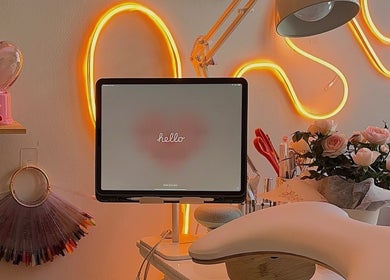 Chic setup at Solara Beauty in Toronto with tablet, flowers, heart decor, and neon lighting.