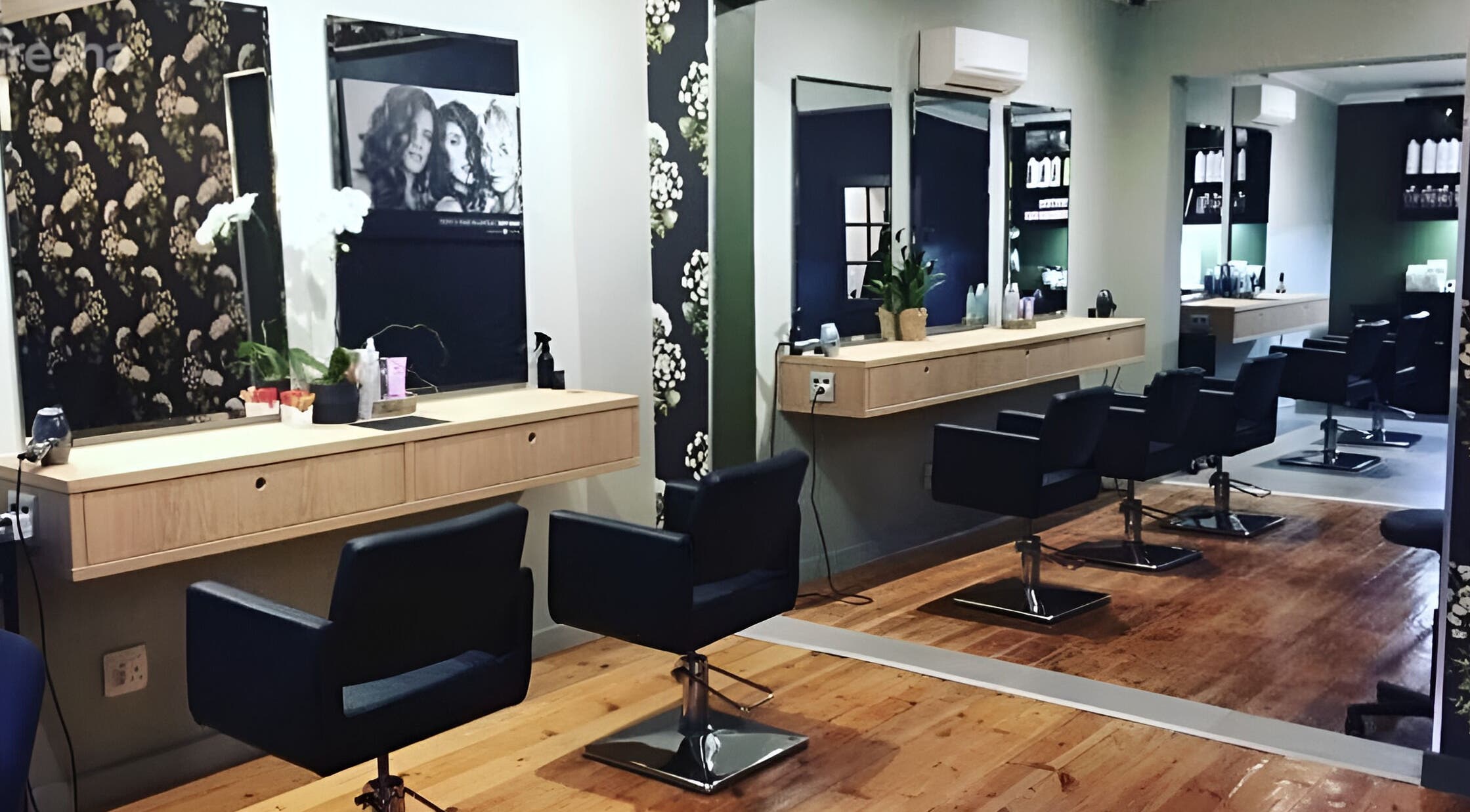 Modern salon setup at The Loft Hair Studio in Paarl, Western Cape, ZA with stylish chairs and mirrors.