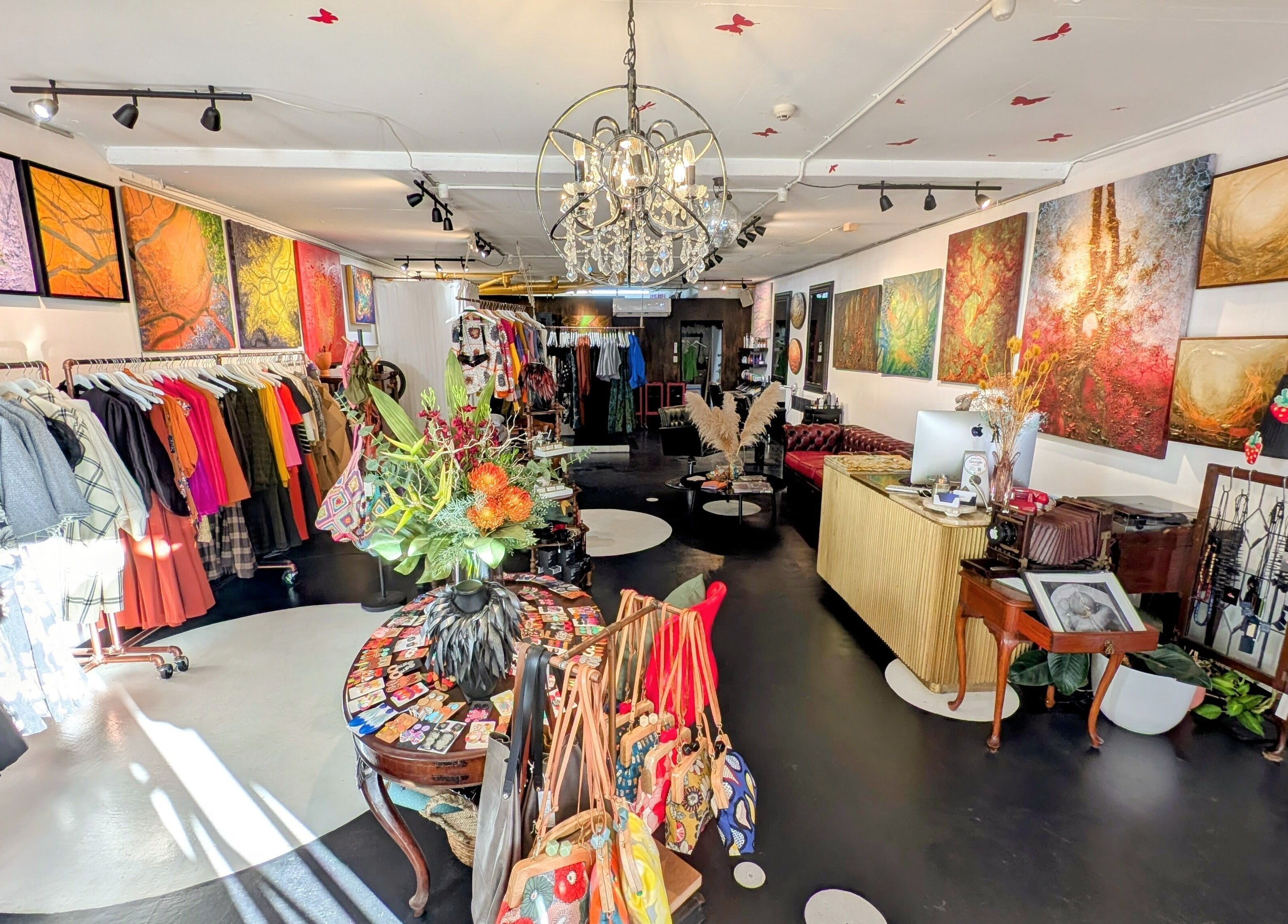 Explore vibrant fashion and decor at Ambo Ars, Newtown, New South Wales, AU, featuring colorful garments and art.