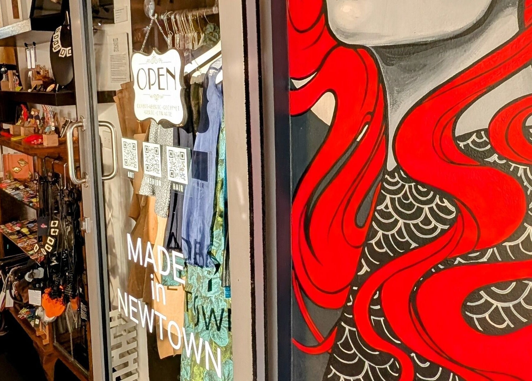 Vibrant storefront mural at Ambo Ars, Newtown, New South Wales, AU showcasing unique artistic designs.