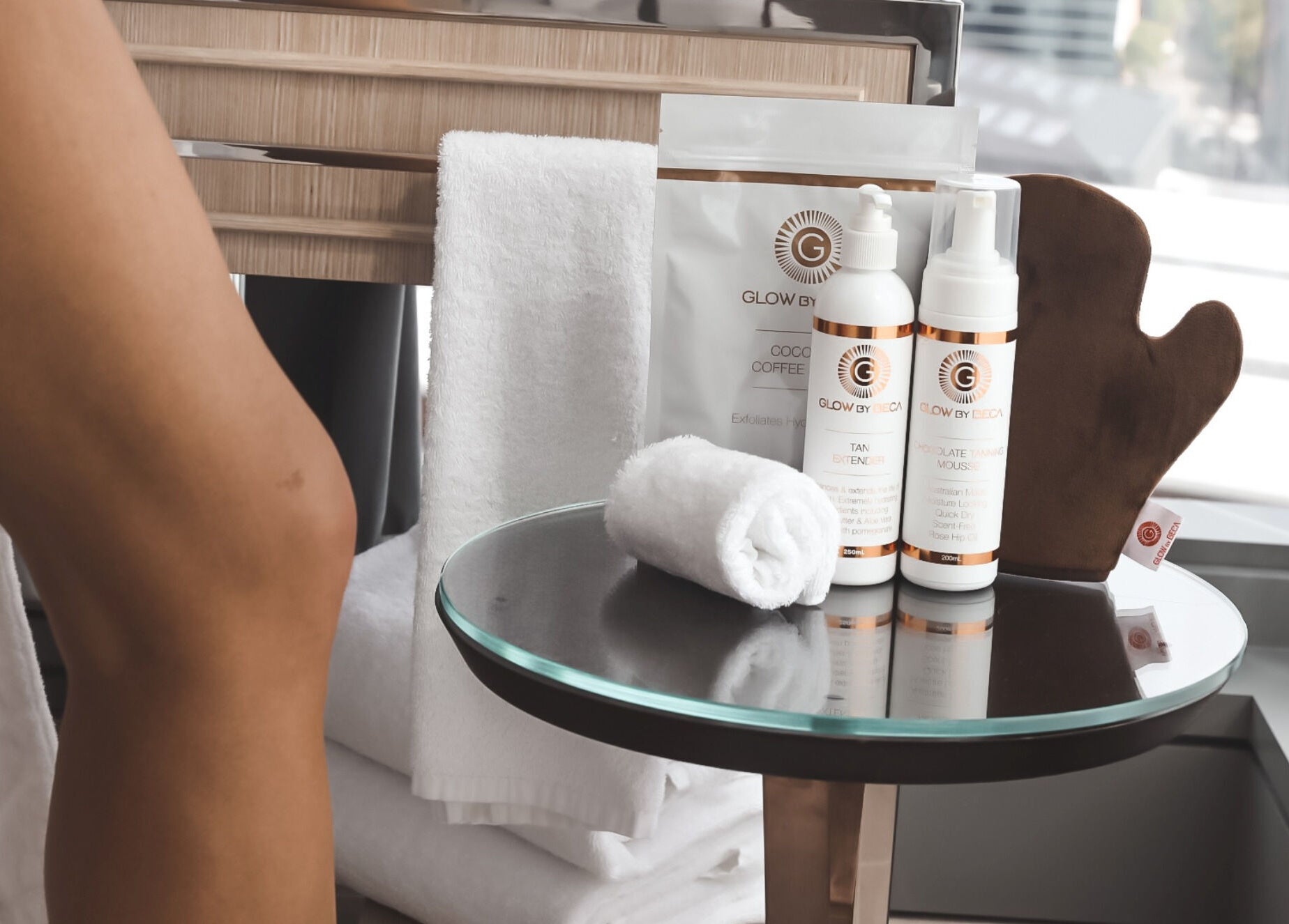 GlowbyBeca skincare products on a glass table at GlowbyBeca, Wilton, New South Wales, AU.