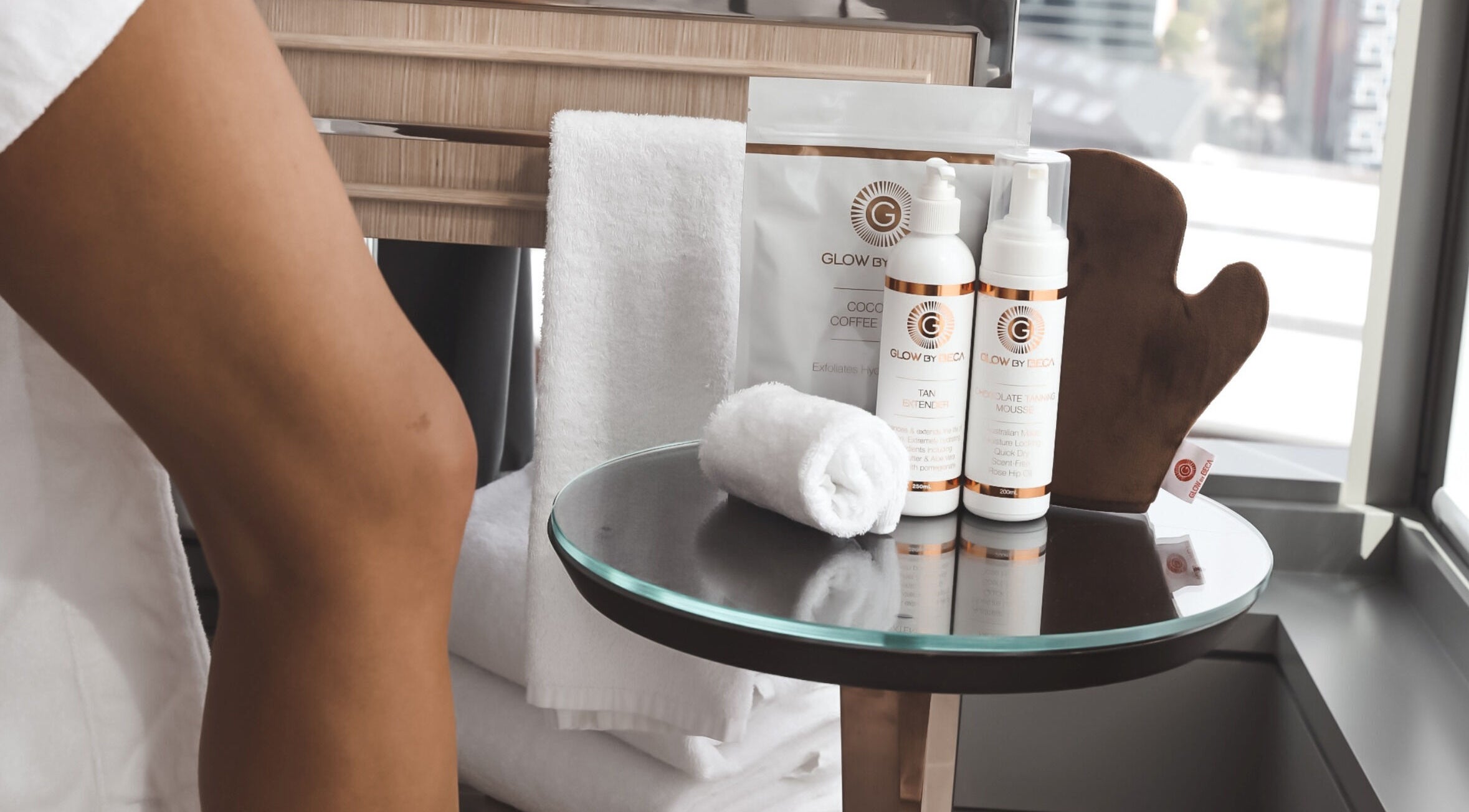 GlowbyBeca skincare products on a glass table at GlowbyBeca, Wilton, New South Wales, AU.