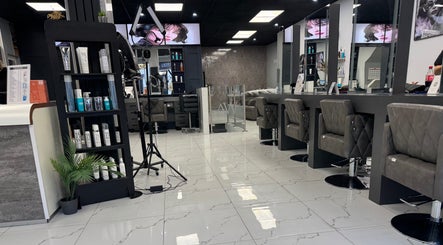 Modern interior of Alaan Williams Hair Experts, Pontypridd, Wales, GB featuring plush chairs and sleek design.