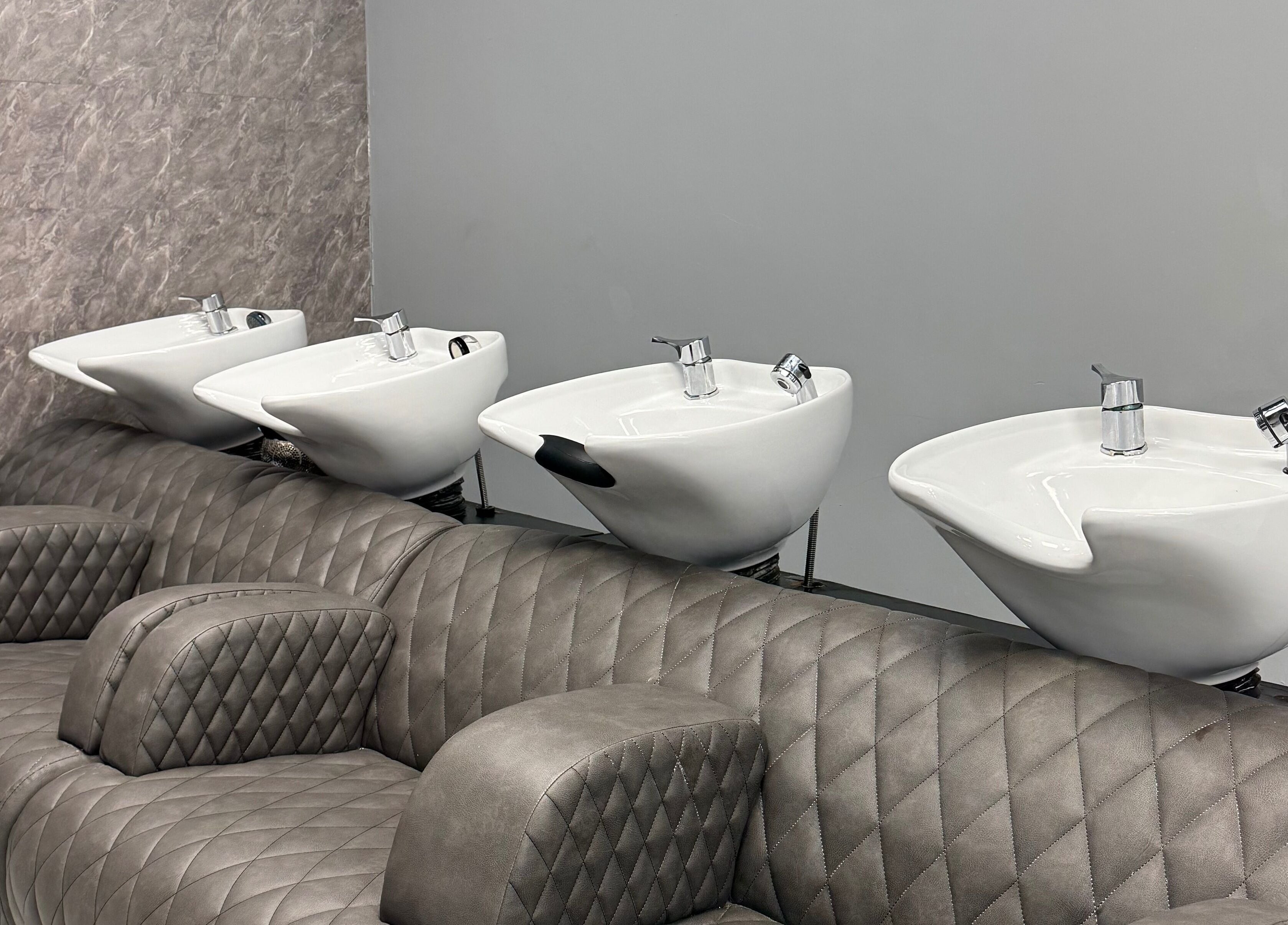 Luxurious wash station at Alaan Williams Hair Experts, Pontypridd, Wales, GB, showcasing quilted seating.