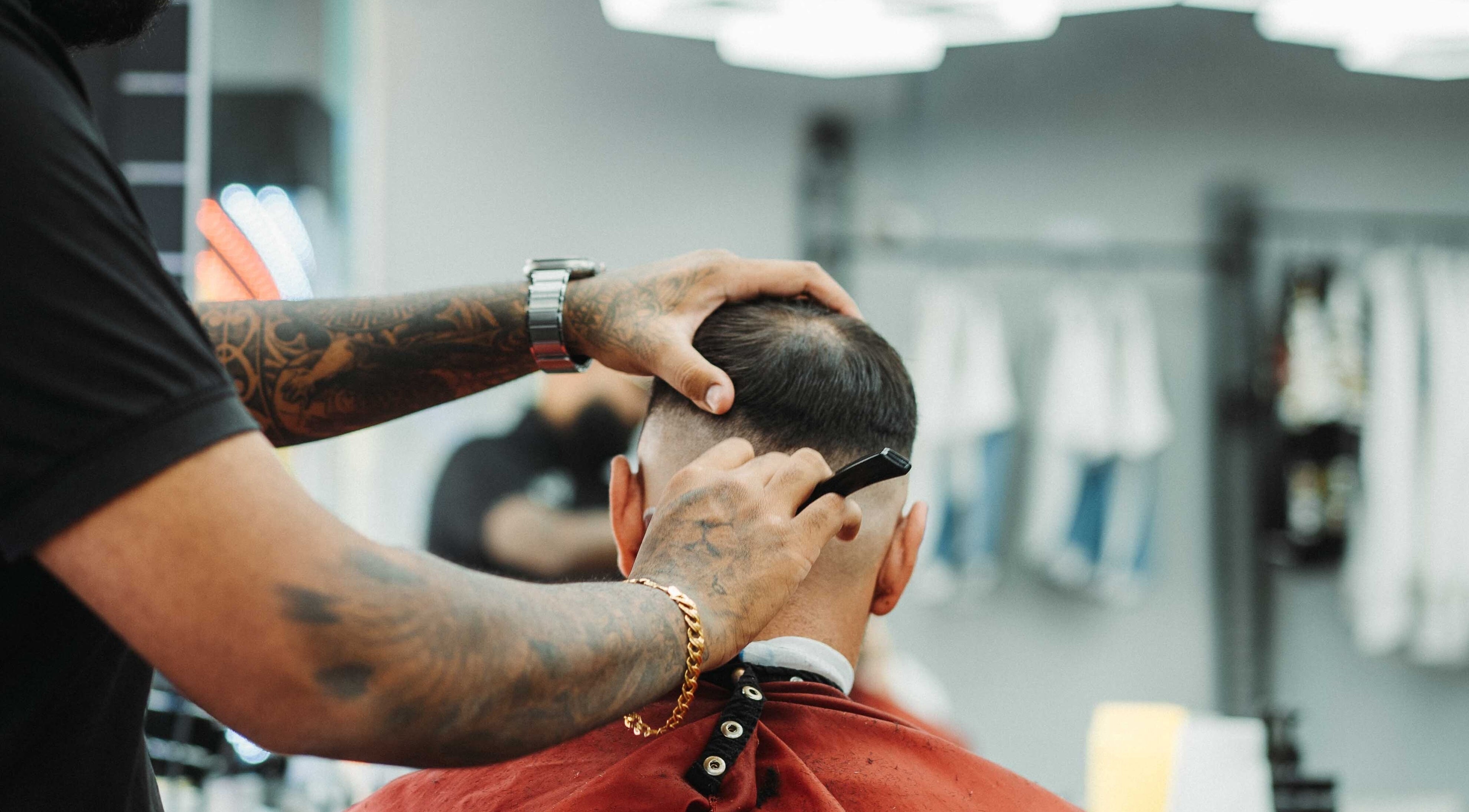 Frankston Barbers in Melbourne, Victoria, AU showcases a precise haircutting technique on a client.