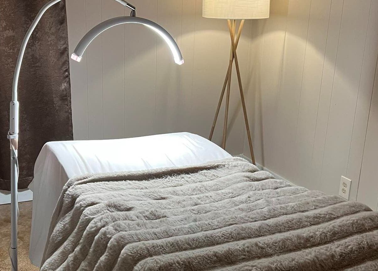 Comfortable treatment bed in Leigh Mac, Opelika, Alabama, US with soft lighting and plush blanket.