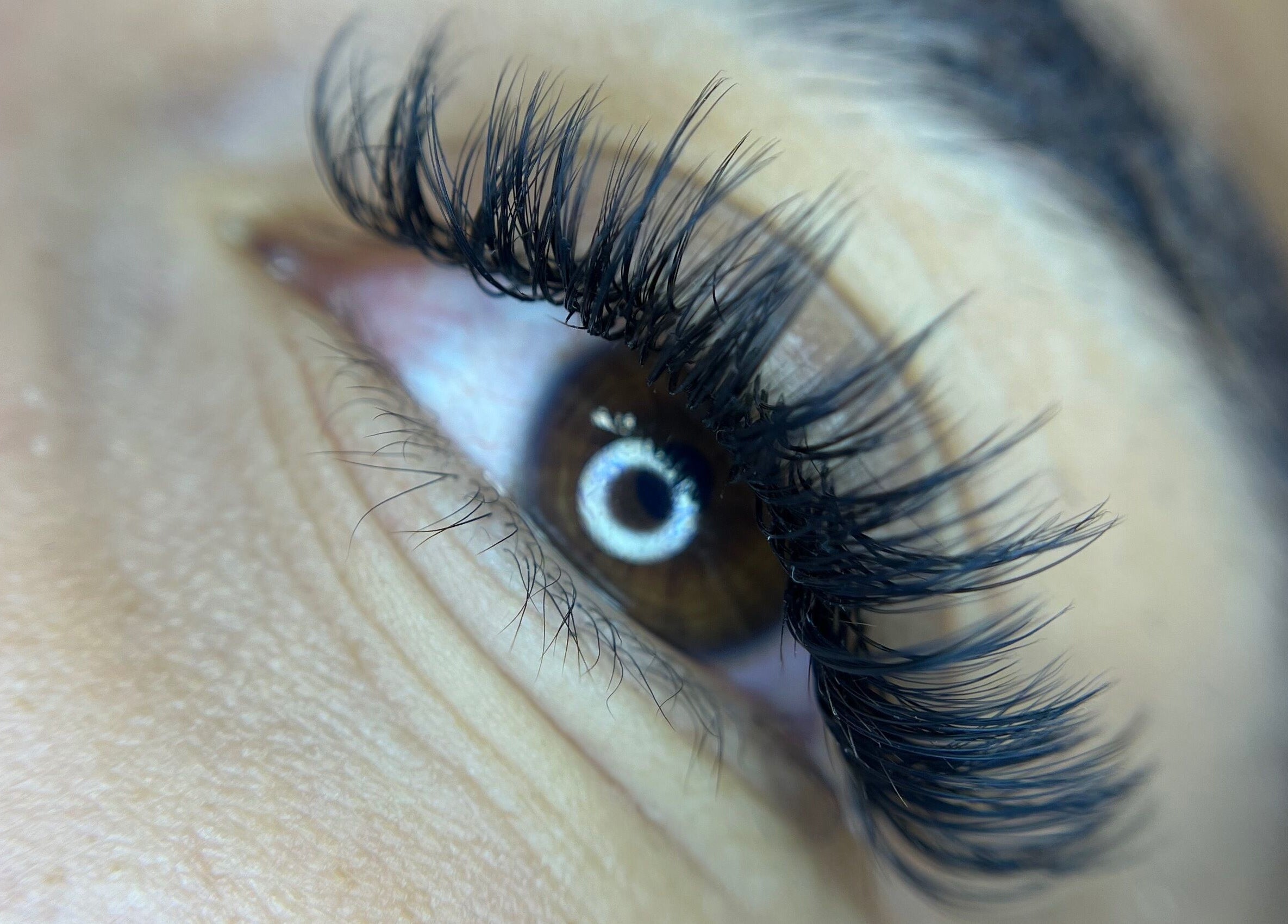 Close-up of expertly applied eyelash extensions at Leigh Mac in Opelika, Alabama, US.