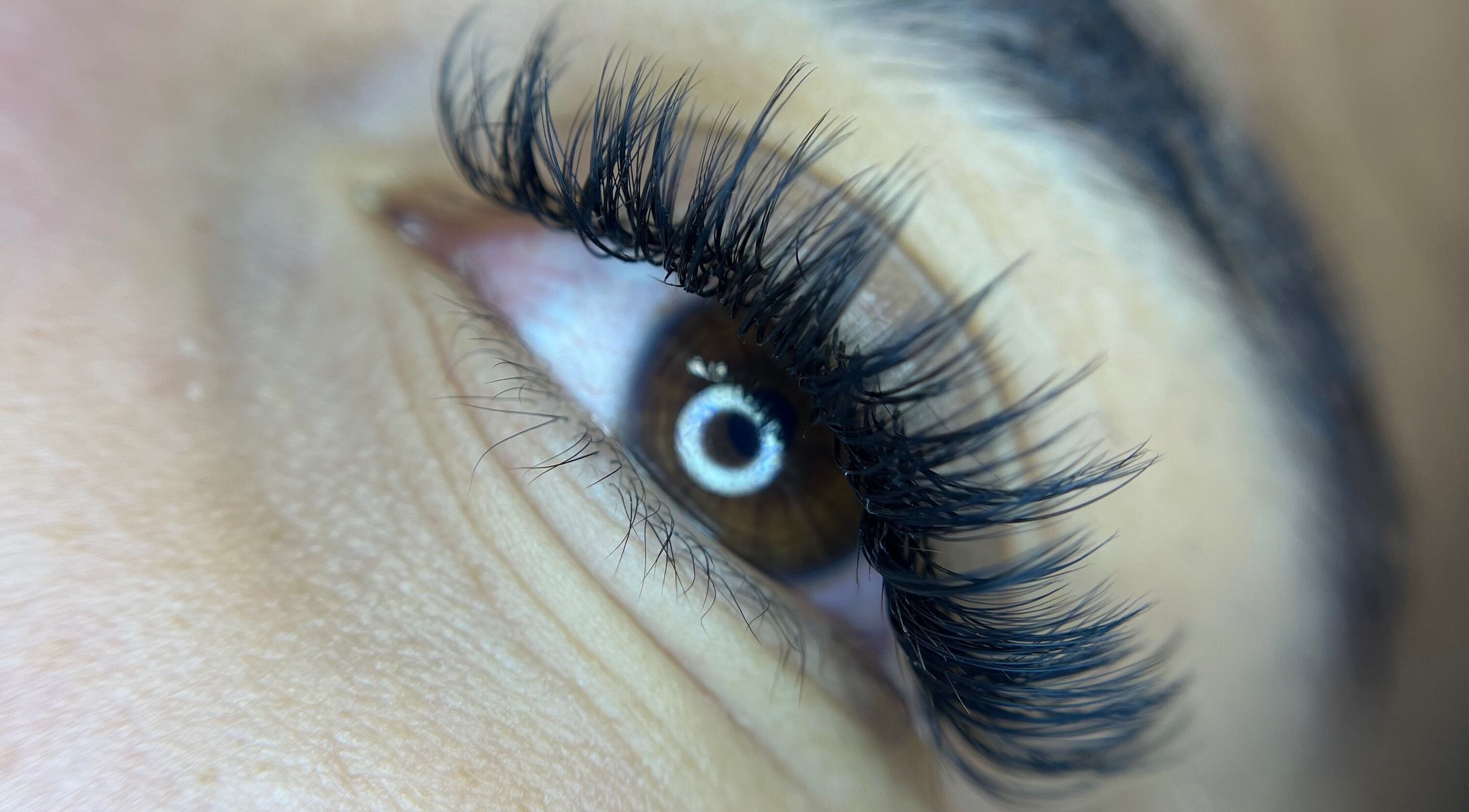 Close-up of expertly applied eyelash extensions at Leigh Mac in Opelika, Alabama, US.