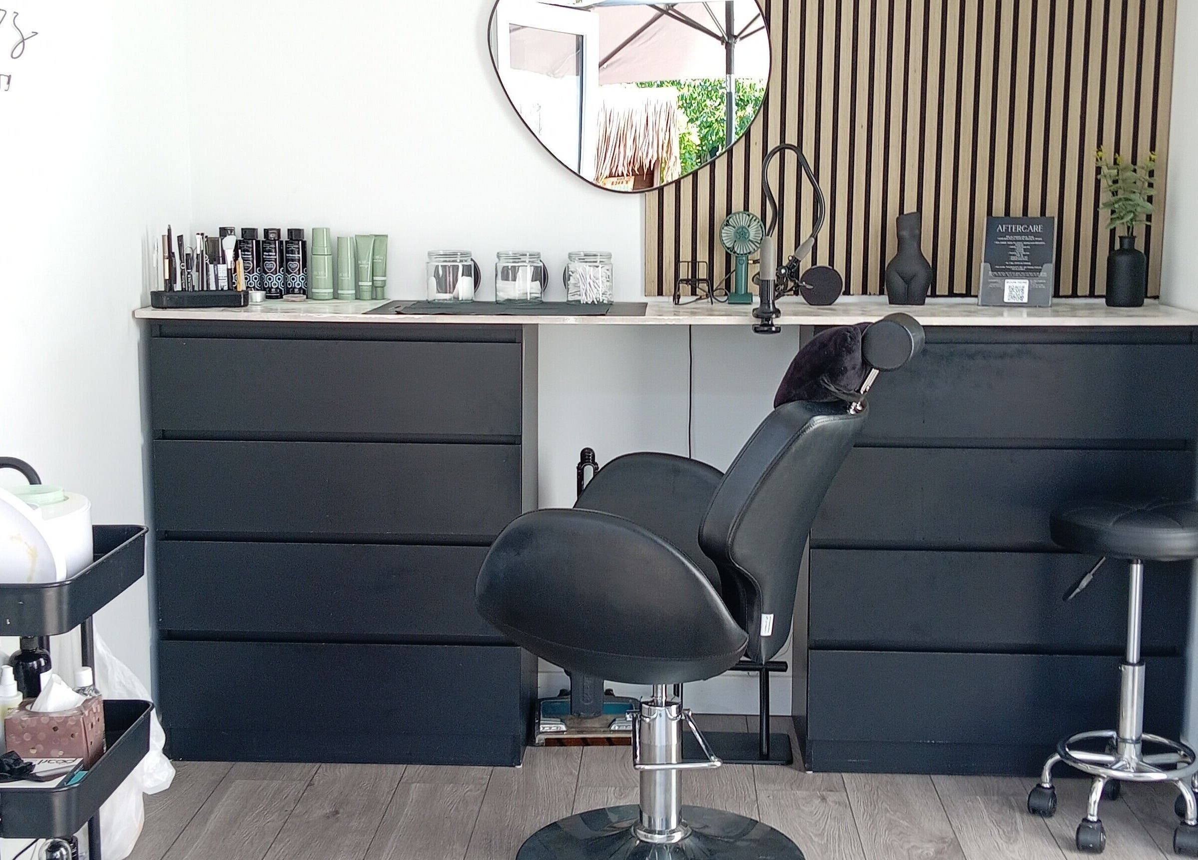 Modern salon setup at Nicole's Brows and Beauty, Sheerness, England, GB featuring sleek chairs and products.
