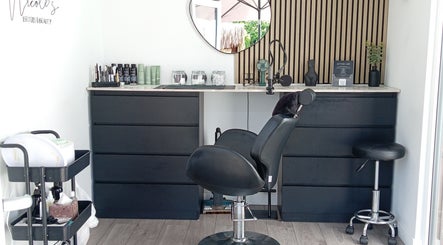 Modern salon setup at Nicole's Brows and Beauty, Sheerness, England, GB featuring sleek chairs and products.