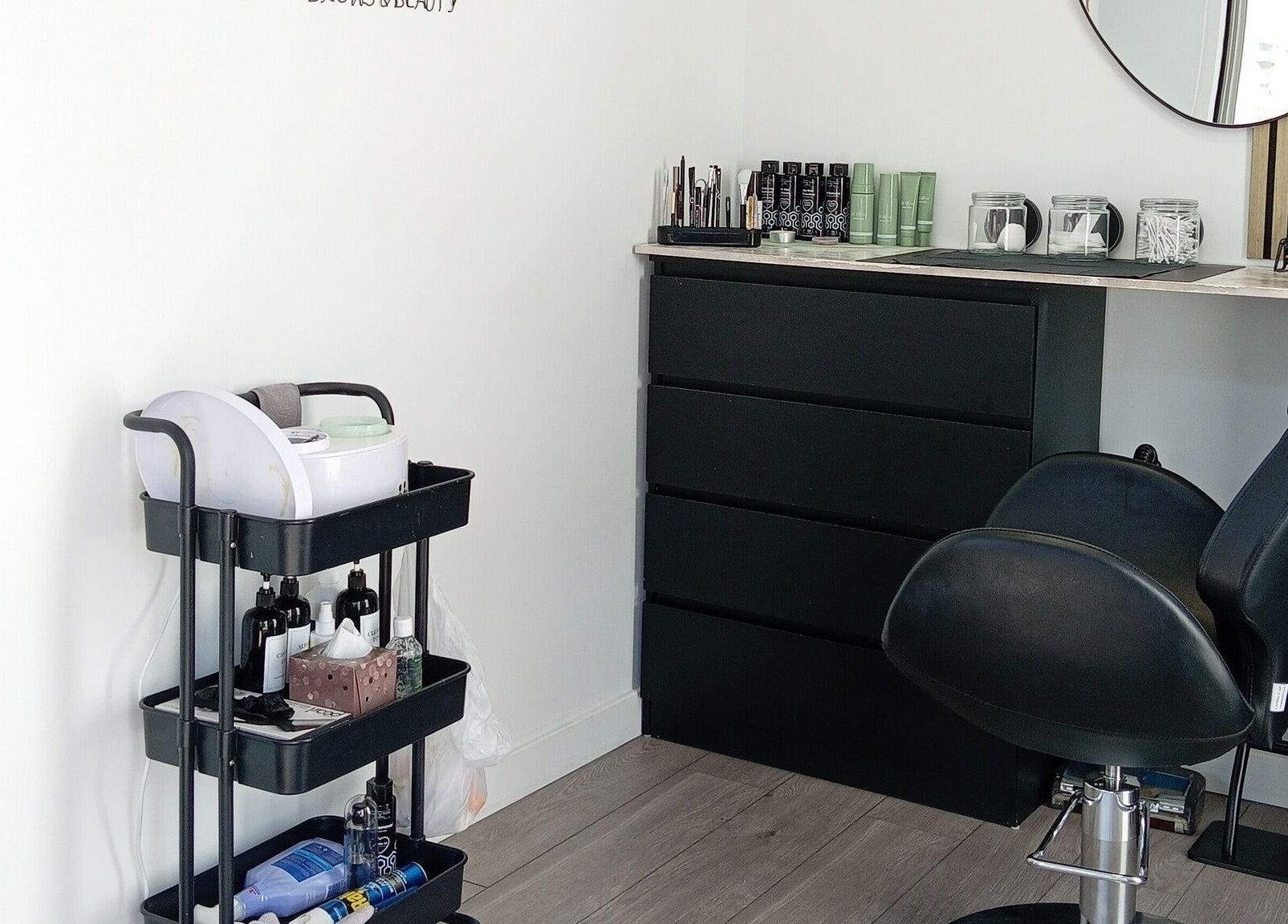 Modern workstation at Nicole's Brows and Beauty, Minster On Sea, England, GB with salon chair and products.