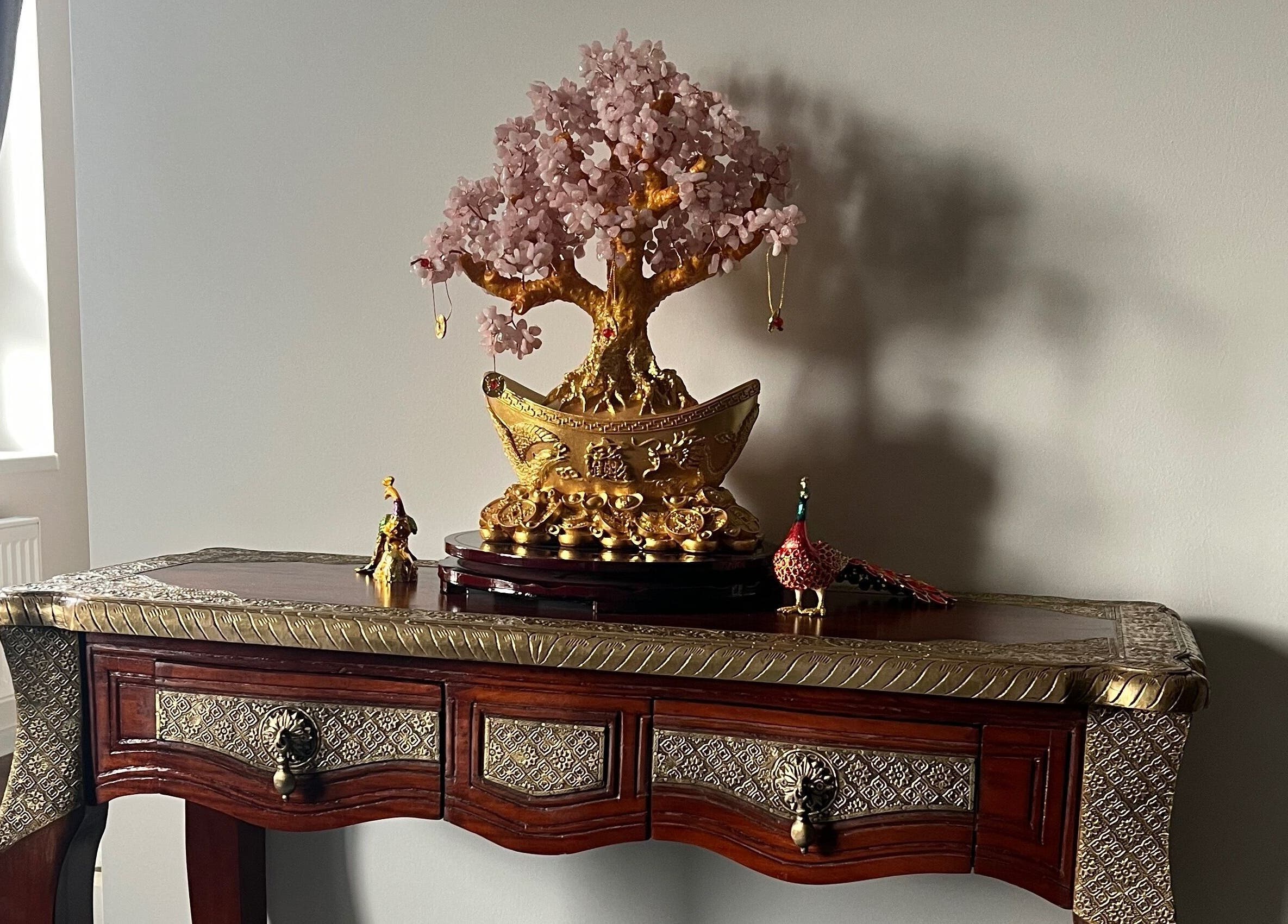 Elegant decorative table and golden tree at Thomasova 235/3, Praha 5, Hlavní Město Praha, CZ.
