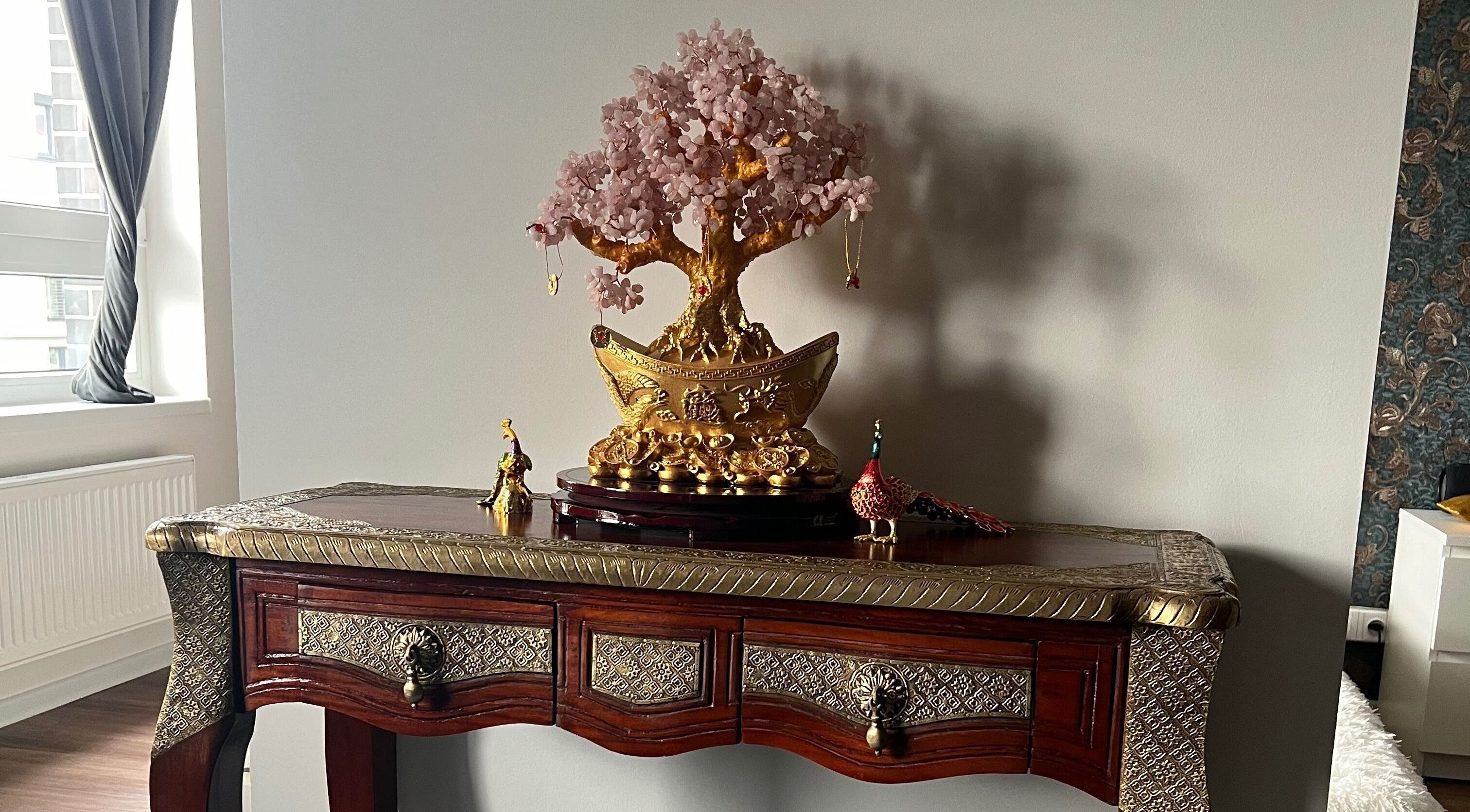 Elegant decorative table and golden tree at Thomasova 235/3, Praha 5, Hlavní Město Praha, CZ.
