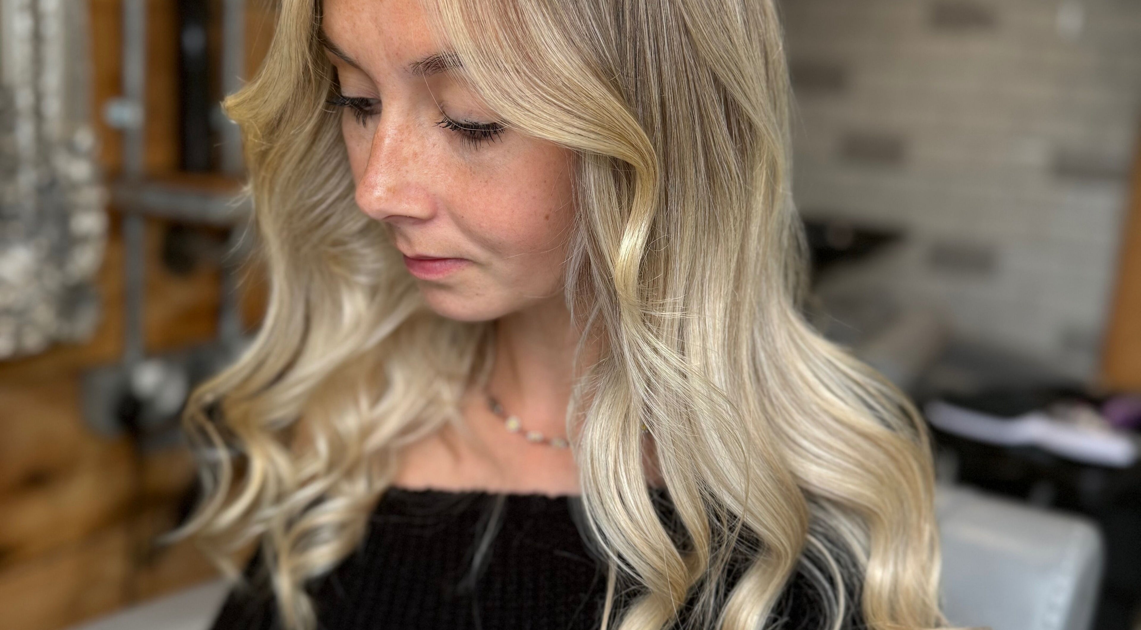 Woman with styled blonde curls at Hair by Jadene, Truro, England, GB.