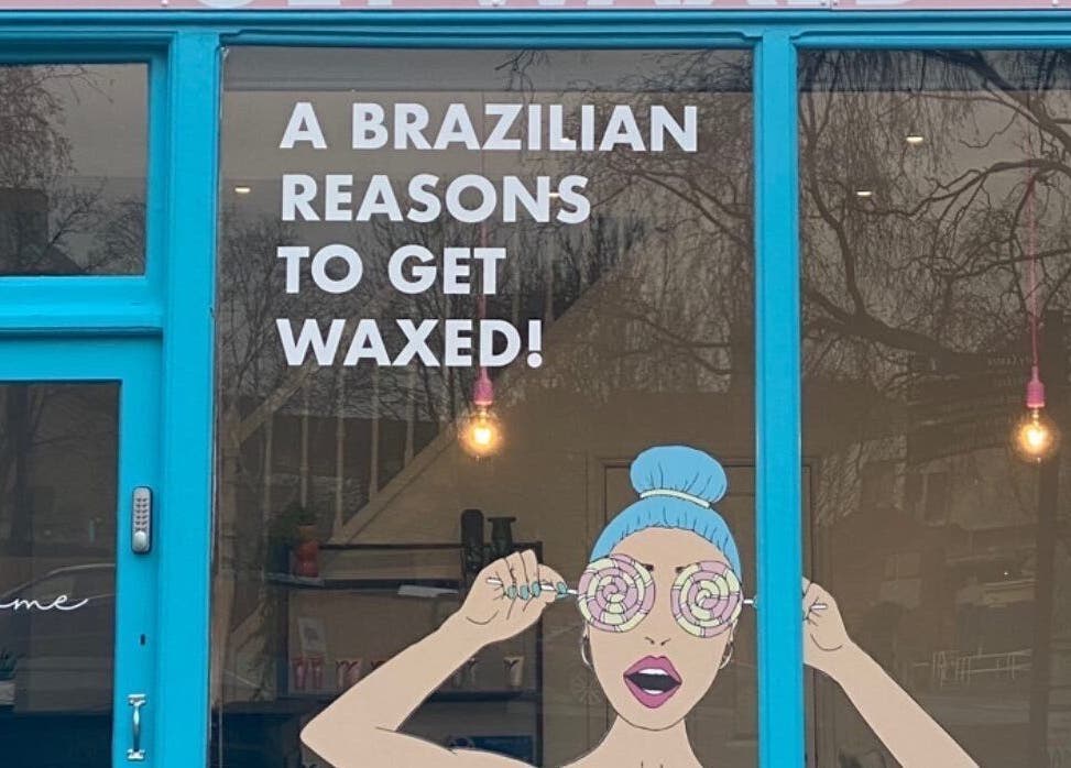 Get Waxed storefront in Gloucester, England, GB, featuring vibrant blue decor and playful window artwork.