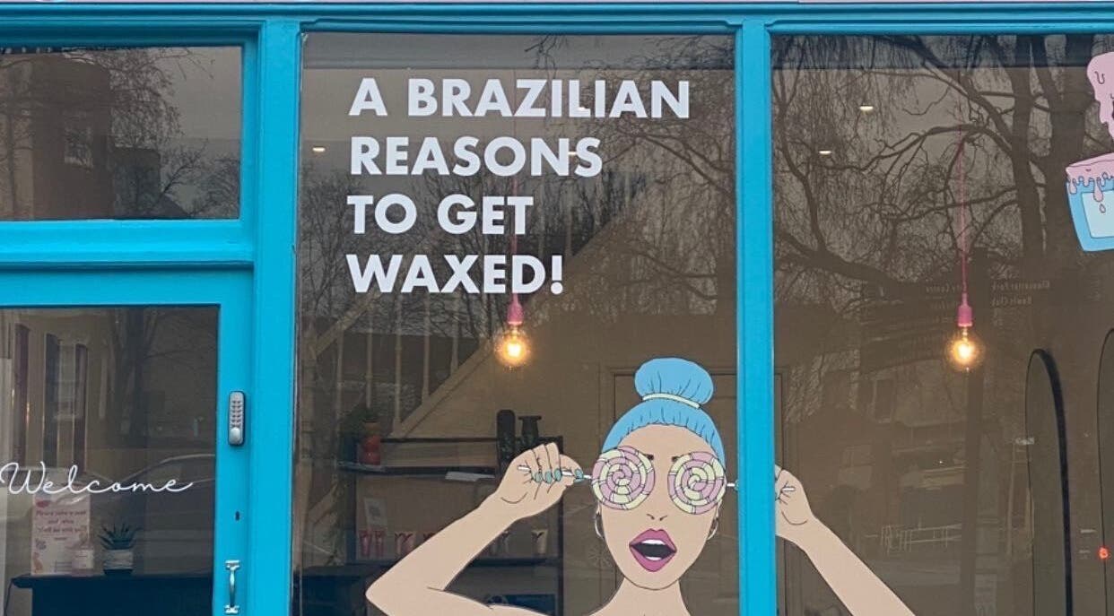 Get Waxed storefront in Gloucester, England, GB, featuring vibrant blue decor and playful window artwork.