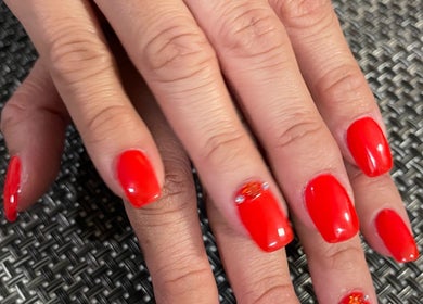 Bold red manicure at ONYX SALON in Miami Beach, Florida, US, showcasing elegant nail art design.