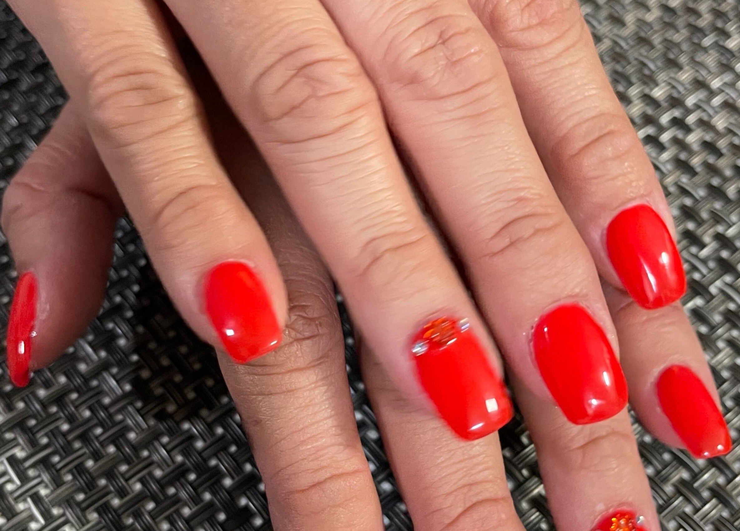 Bold red manicure at ONYX SALON in Miami Beach, Florida, US, showcasing elegant nail art design.