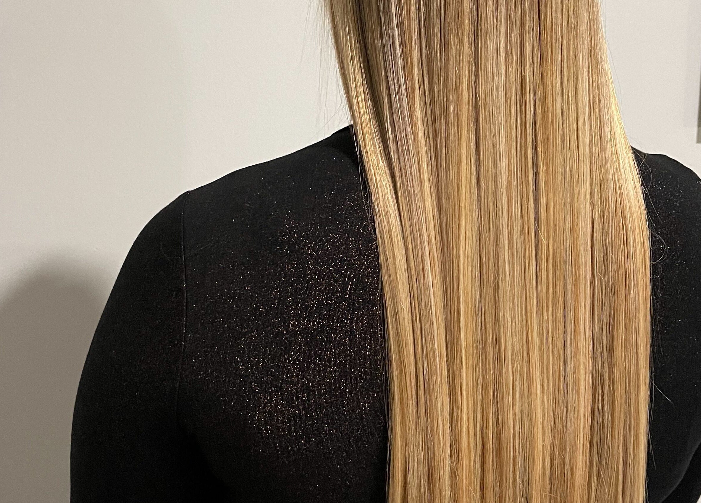 Long, sleek blonde hair styled at ONYX SALON in Miami Beach, Florida, US.