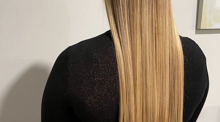 Long, sleek blonde hair styled at ONYX SALON in Miami Beach, Florida, US.