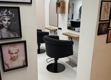 Stylish interior of Shelley Lane Salon in Aberkenfig, Wales, GB with framed artwork and cozy styling chairs.