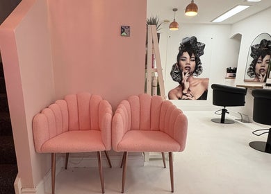 Modern interior of Shelley Lane Salon in Aberkenfig, Wales, GB with pink chairs and stylish wall art.