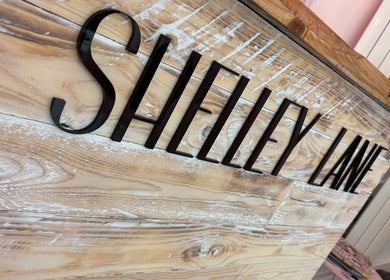 Shelley Lane Salon wooden sign at Aberkenfig, Wales, GB showcasing elegant aesthetics.