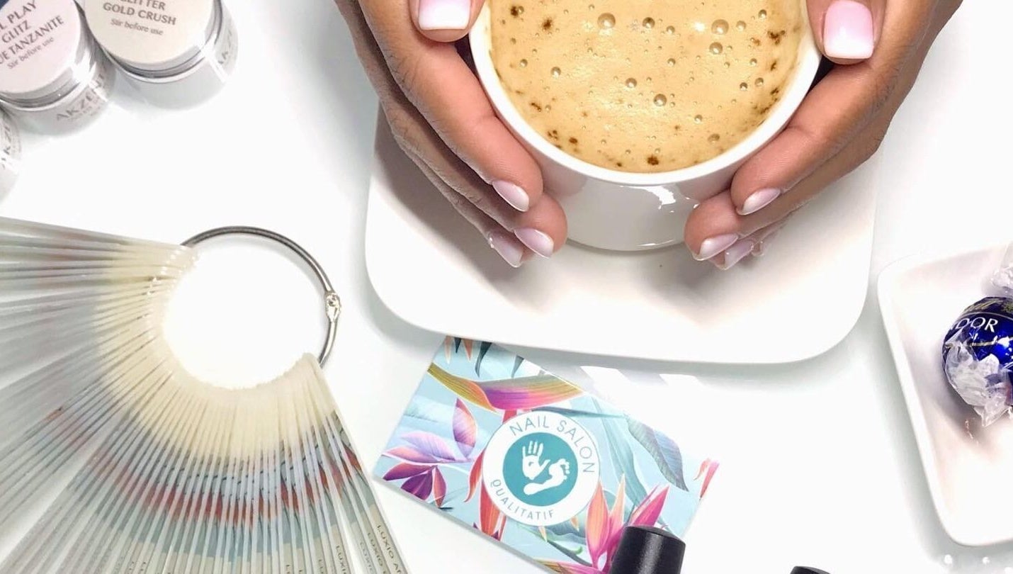 Cup of coffee and manicured hands at Nail Salon Qualitatif, Port Elizabeth, Eastern Cape, ZA.