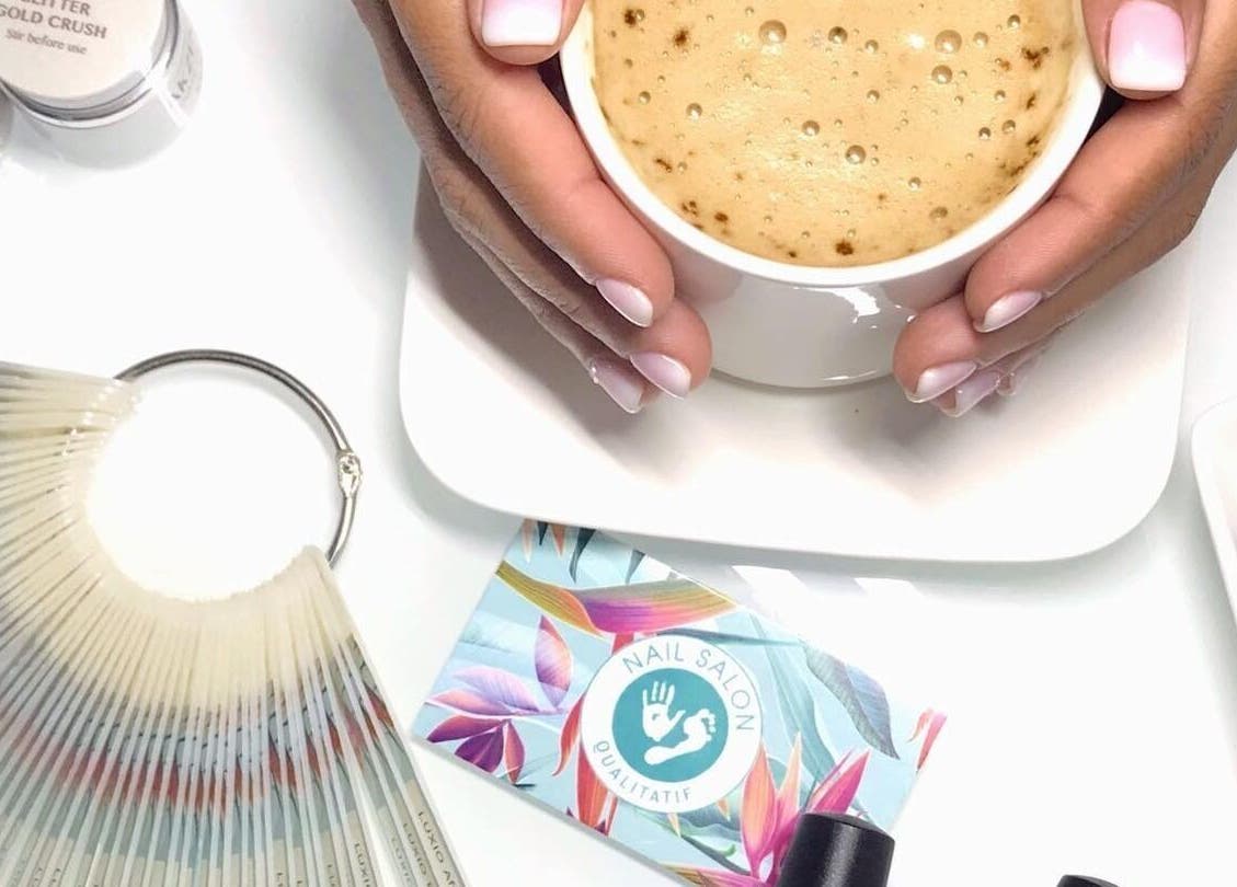 Cup of coffee and manicured hands at Nail Salon Qualitatif, Port Elizabeth, Eastern Cape, ZA.