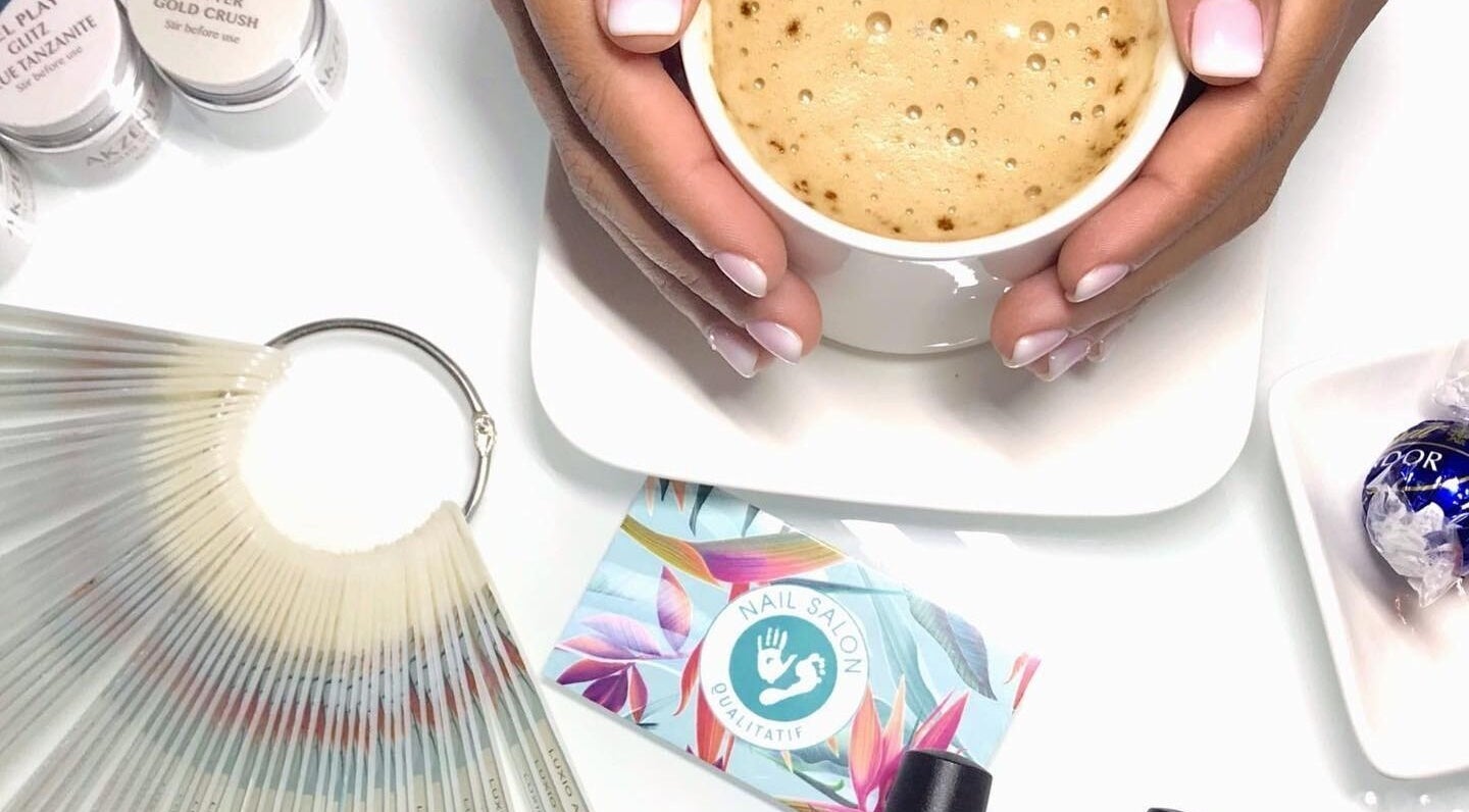 Cup of coffee and manicured hands at Nail Salon Qualitatif, Port Elizabeth, Eastern Cape, ZA.