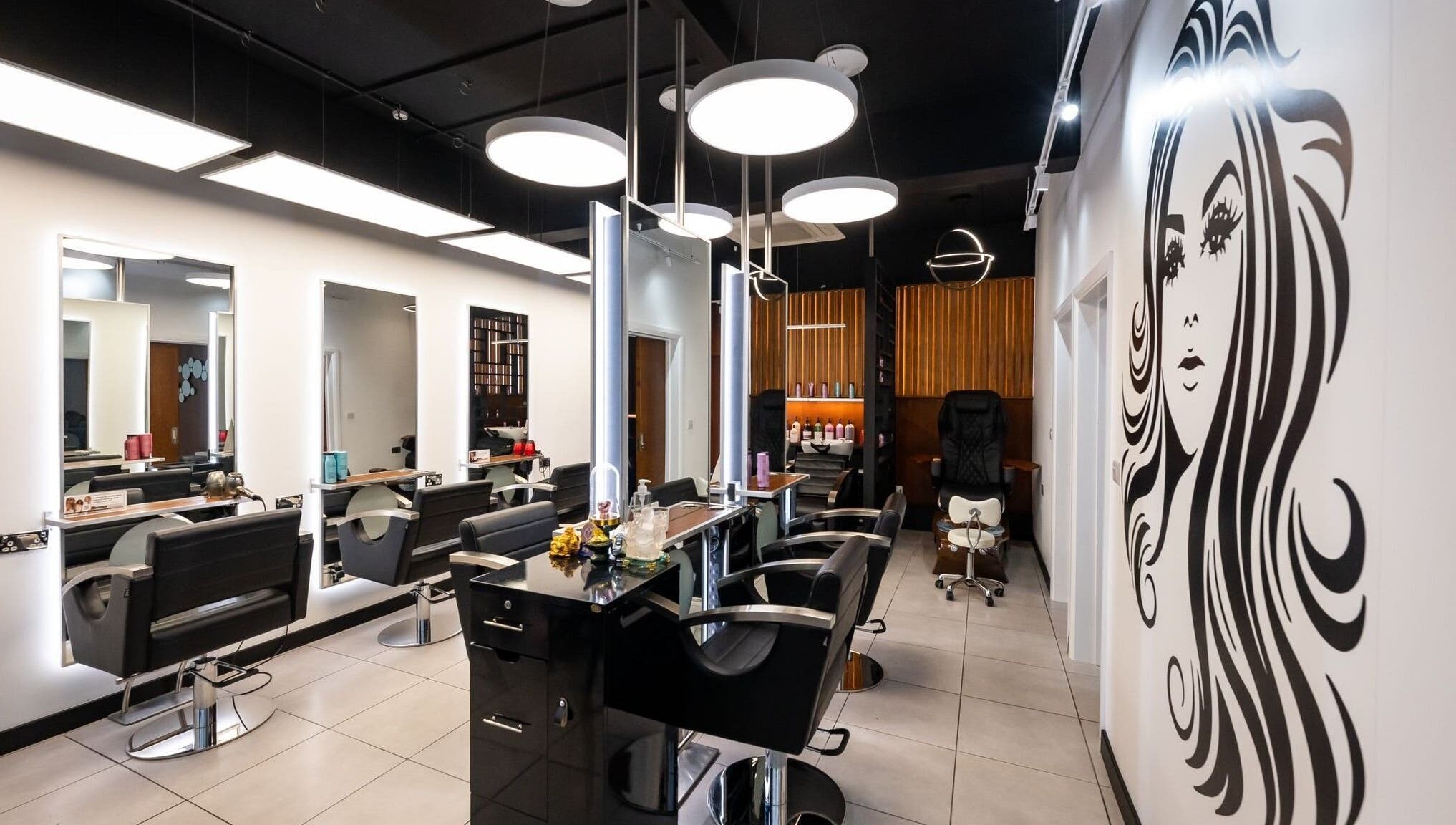 Modern interior of Kapil Hair Studio, Harrow, England, GB showcasing stylish salon chairs and decor.