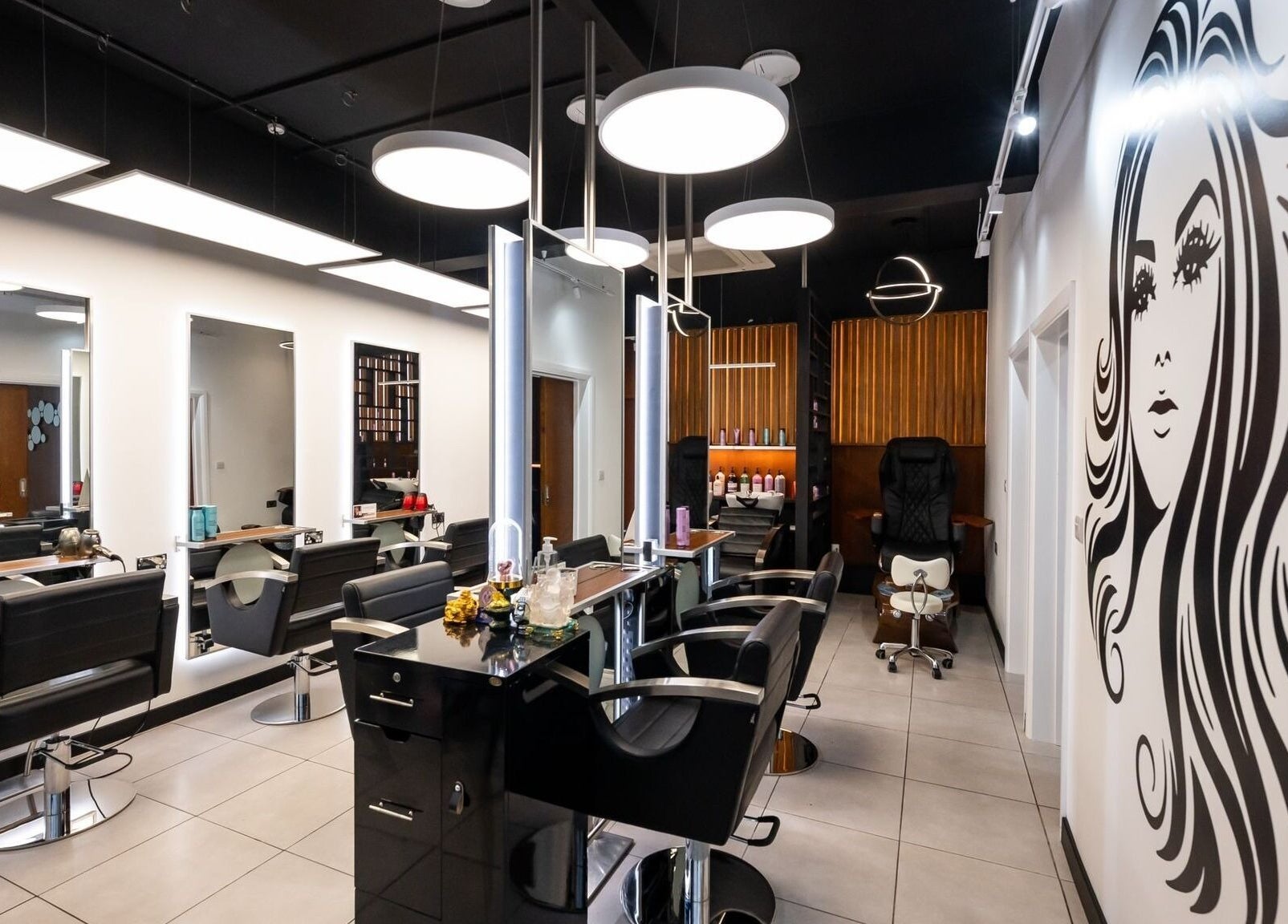 Modern interior of Kapil Hair Studio, Harrow, England, GB showcasing stylish salon chairs and decor.