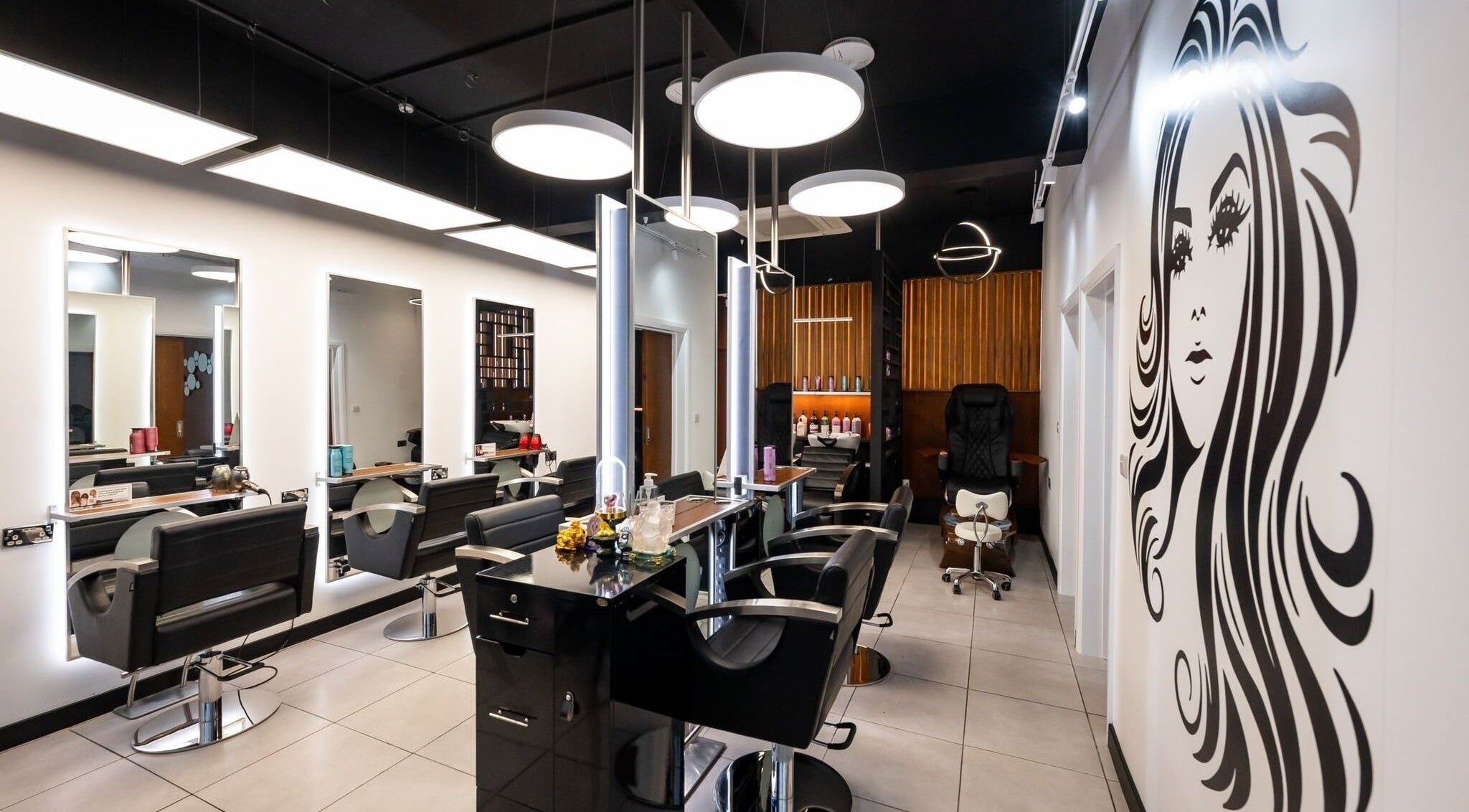 Modern interior of Kapil Hair Studio, Harrow, England, GB showcasing stylish salon chairs and decor.