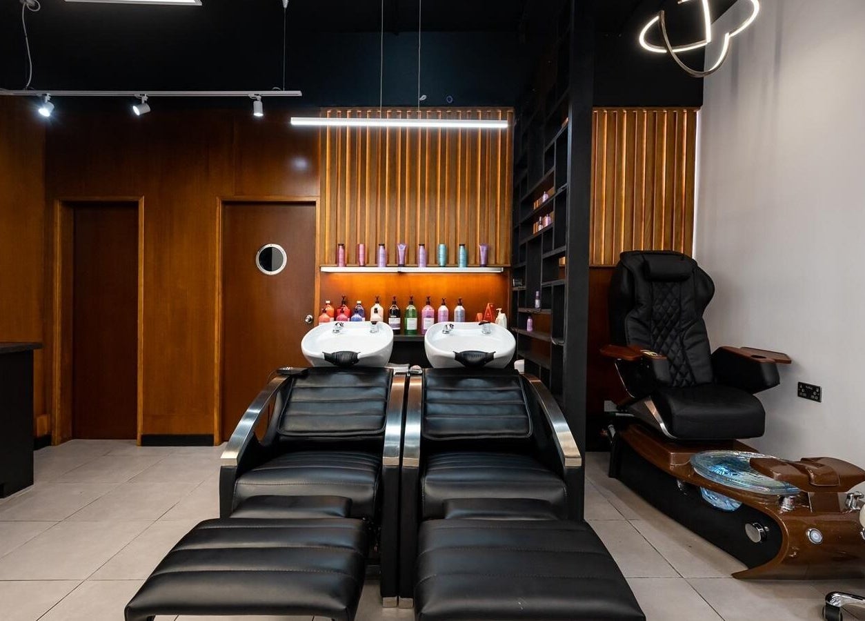 Modern hair washing stations at Kapil Hair Studio, Harrow, England. Luxurious spa ambiance with sleek seating.
