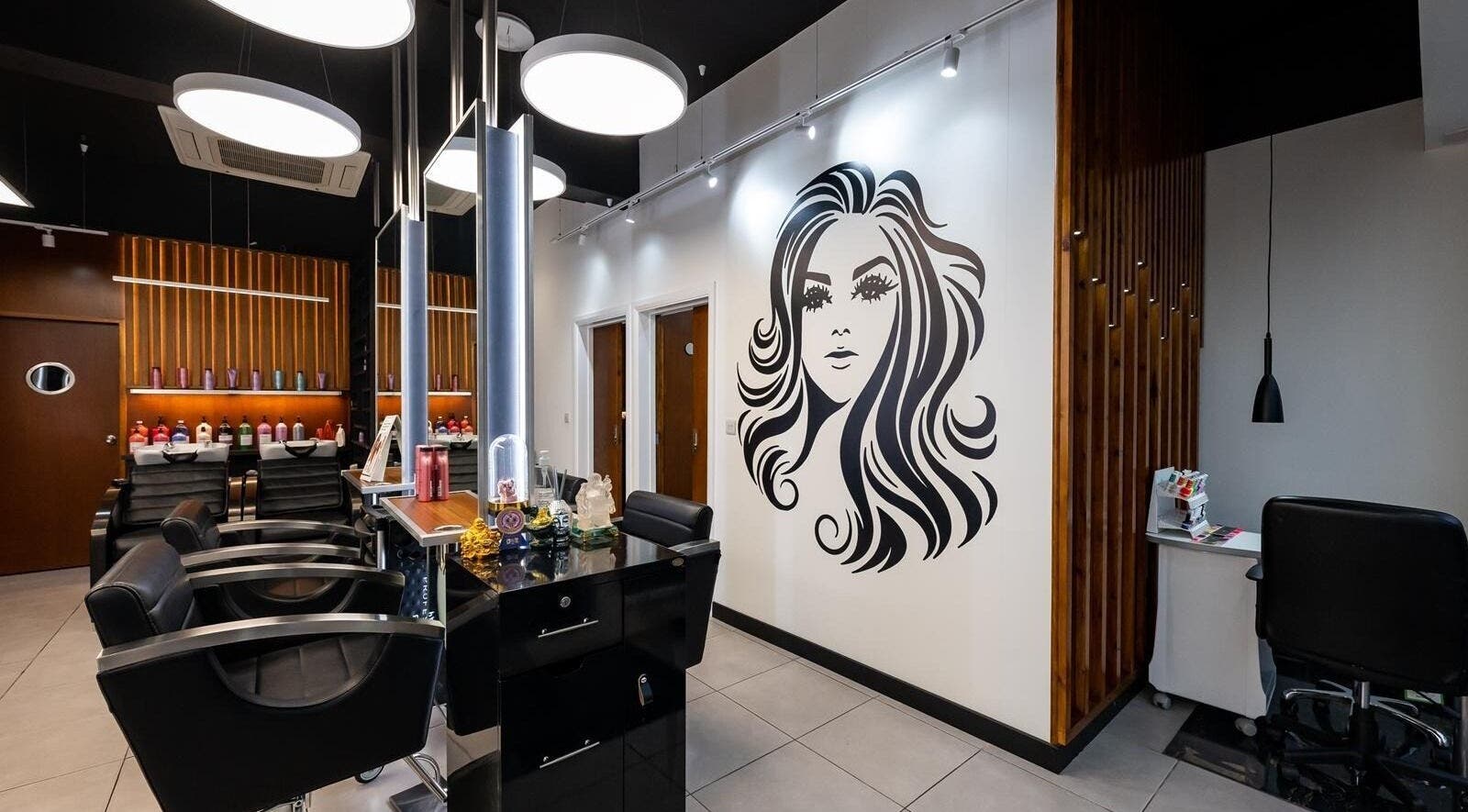 Interior of Kapil Hair Studio featuring stylish salon chairs and decor in Harrow, England, GB.