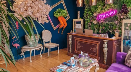 Stylish reception at Forever Clinic, Cheltenham, England, GB with vibrant decor and unique wall art.