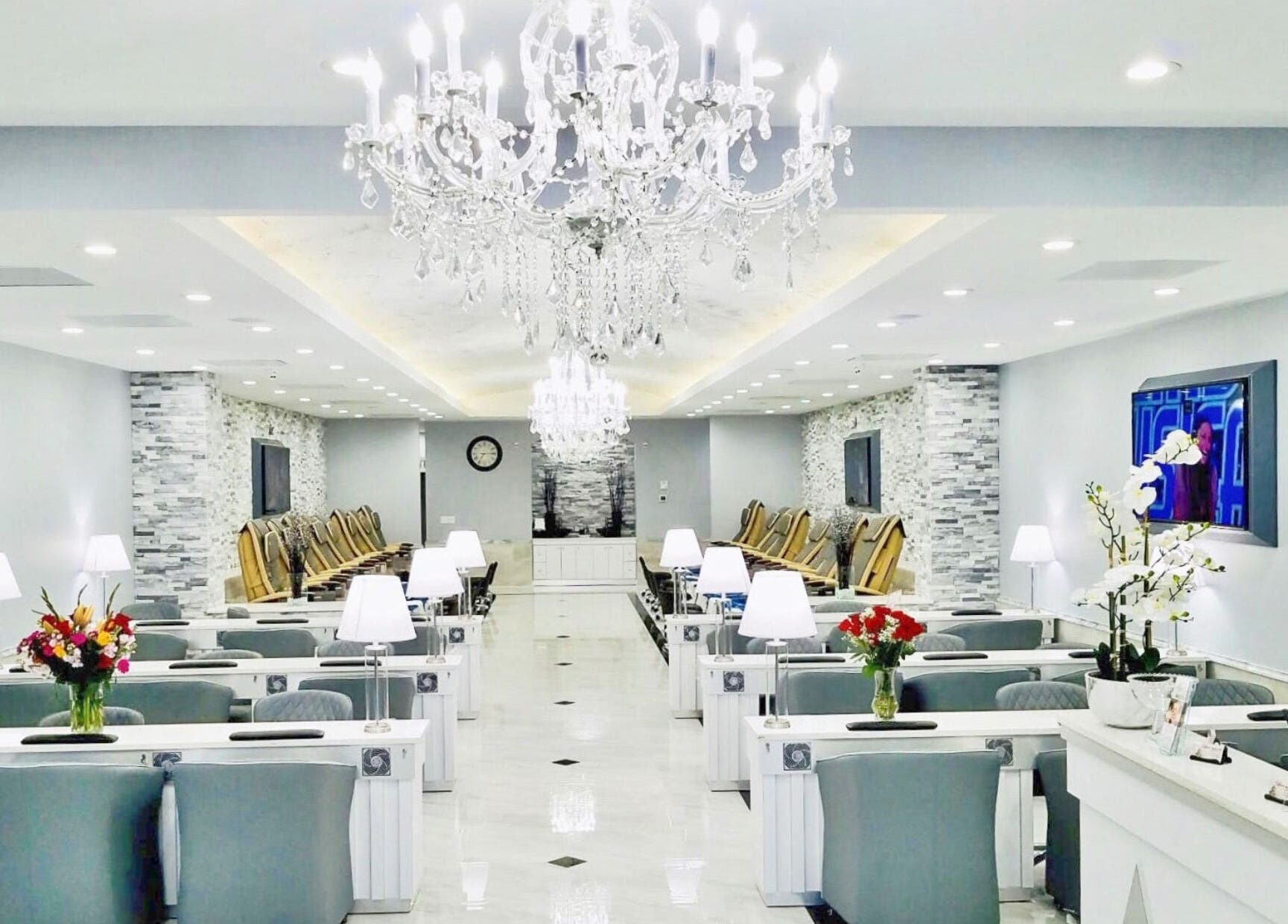Luxurious Wynn Nail Spa interior in Maineville, Ohio, US with elegant chandeliers and stylish seating.