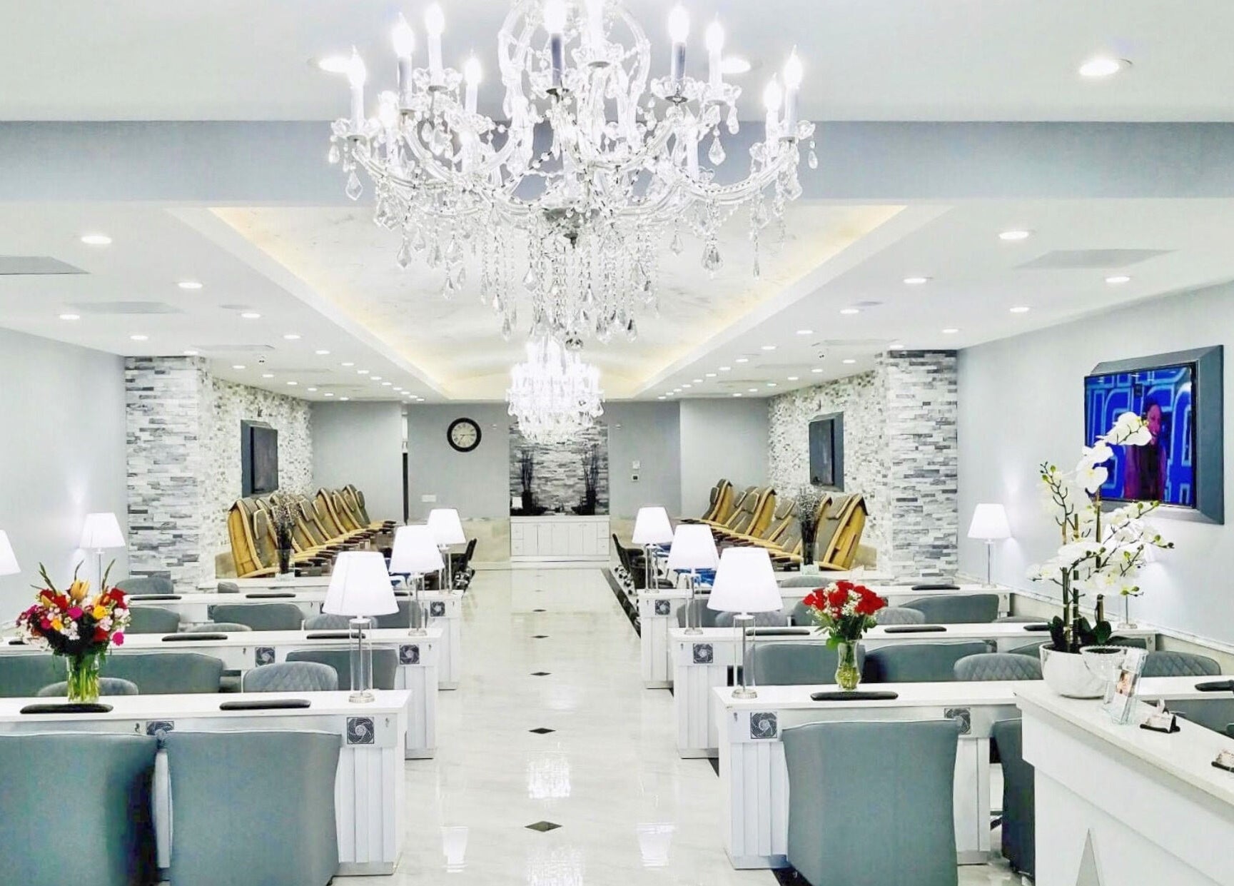 Luxurious Wynn Nail Spa interior in Maineville, Ohio, US with elegant chandeliers and stylish seating.
