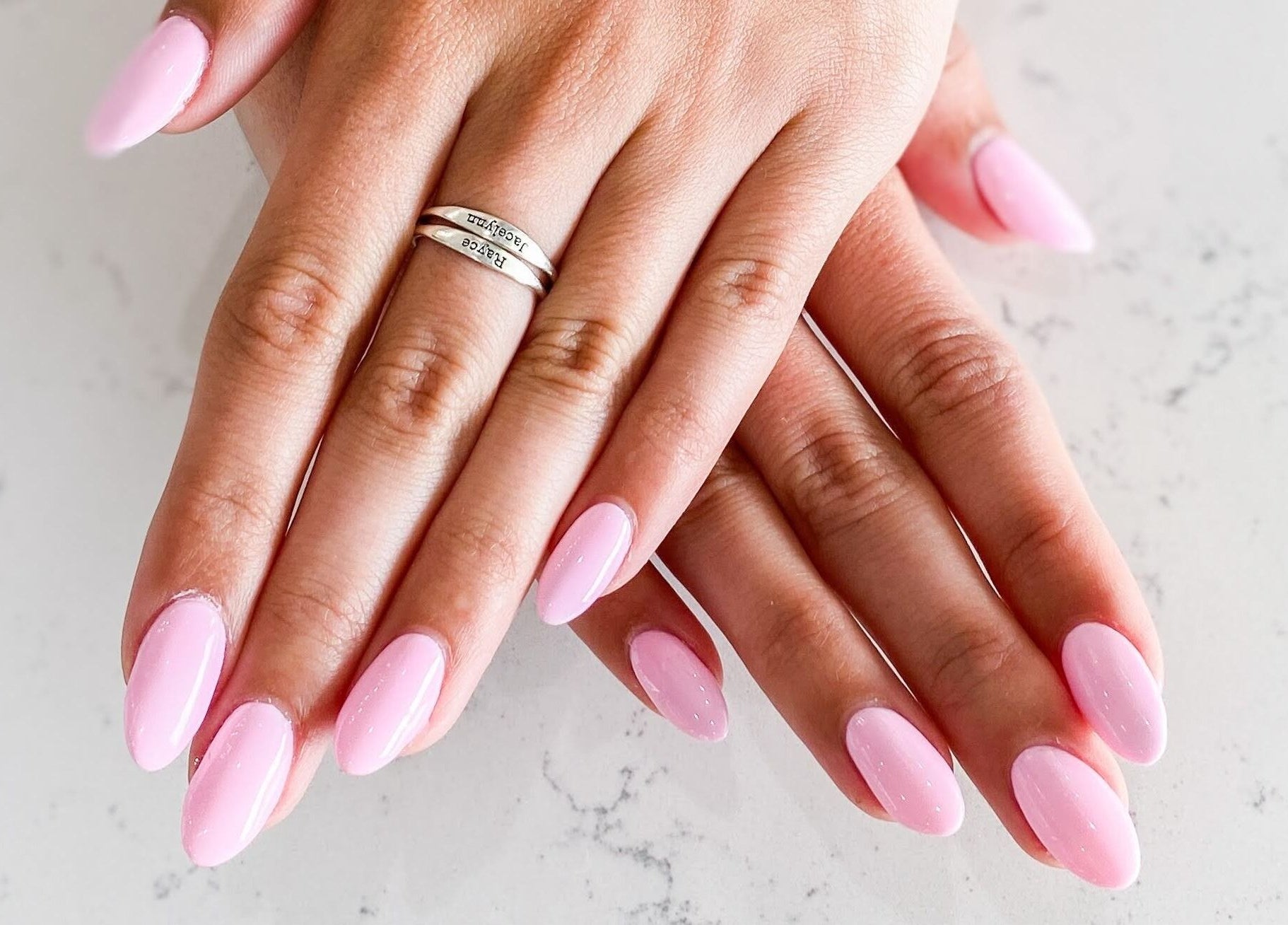 Beautiful pink manicured nails at Wynn Nail Spa, Maineville, Ohio, US. Perfectly groomed hands showcasing nail art.