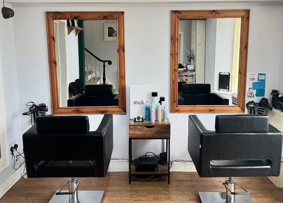 Interior of David Charles Hair, Health and Beauty Studio in Raunds, England, featuring stylish salon chairs and mirrors.