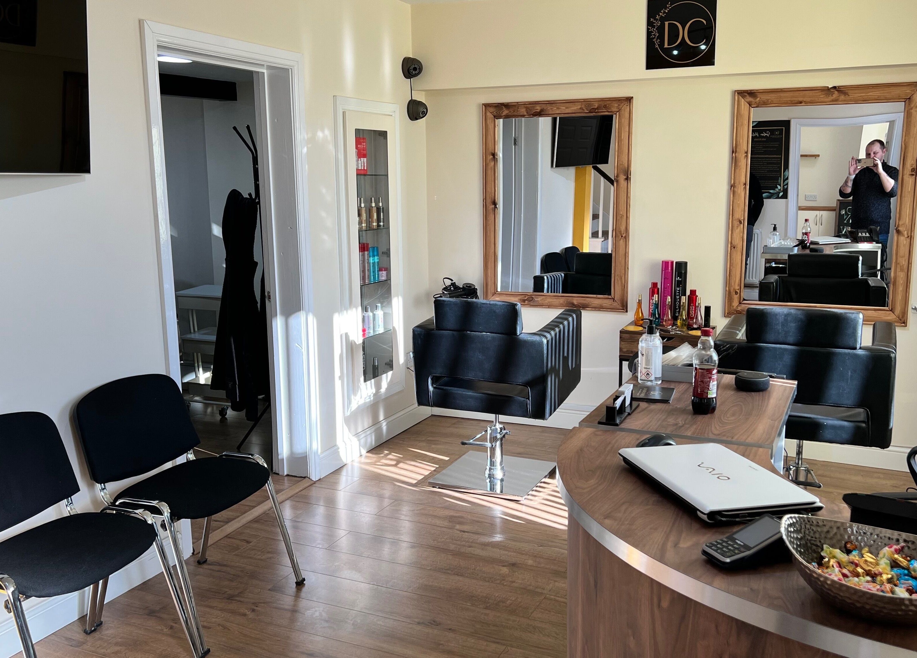 Interior of David Charles Hair, Health and Beauty Studio in Raunds, England, GB with stylish chairs and mirrors.
