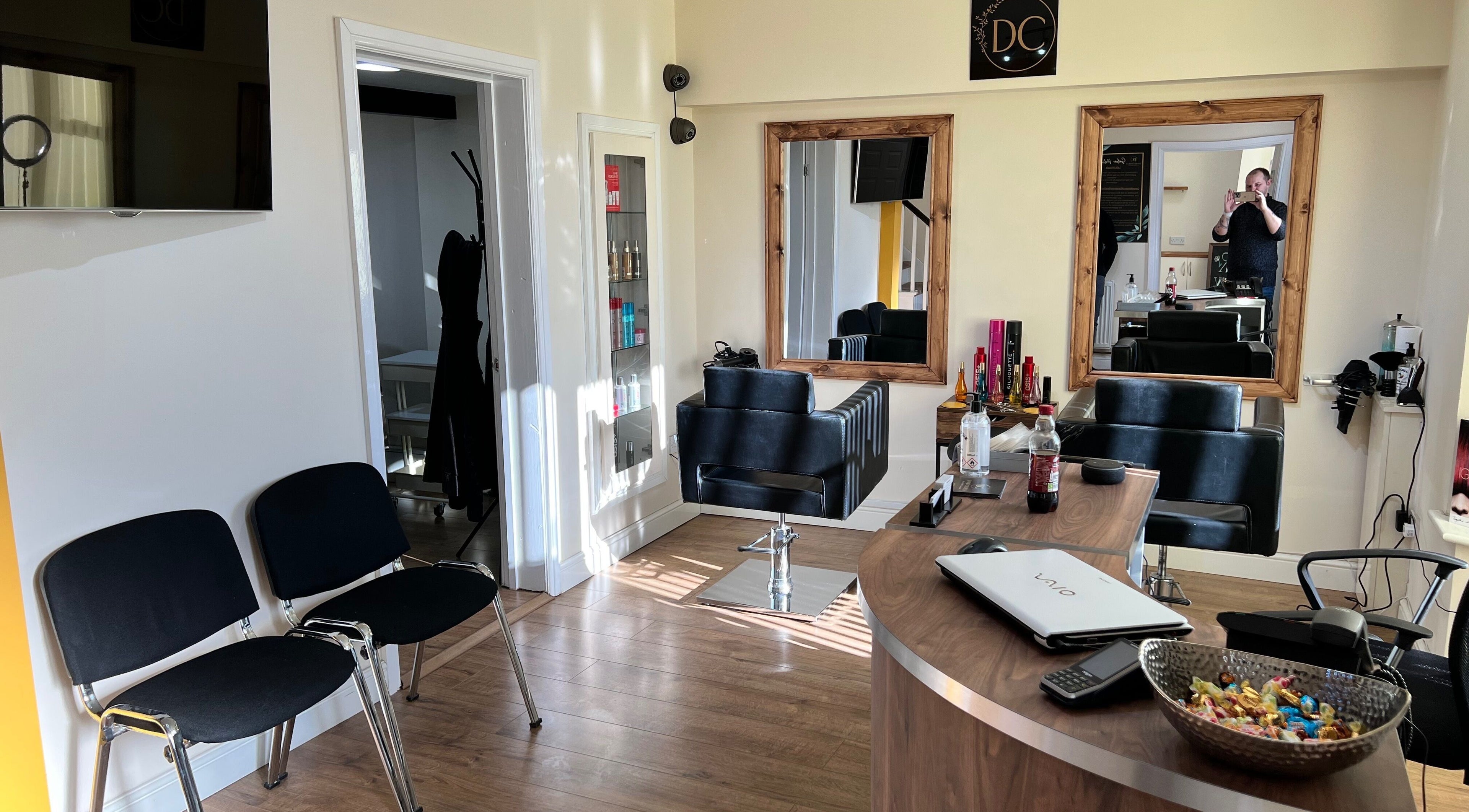 Interior of David Charles Hair, Health and Beauty Studio in Raunds, England, GB with stylish chairs and mirrors.