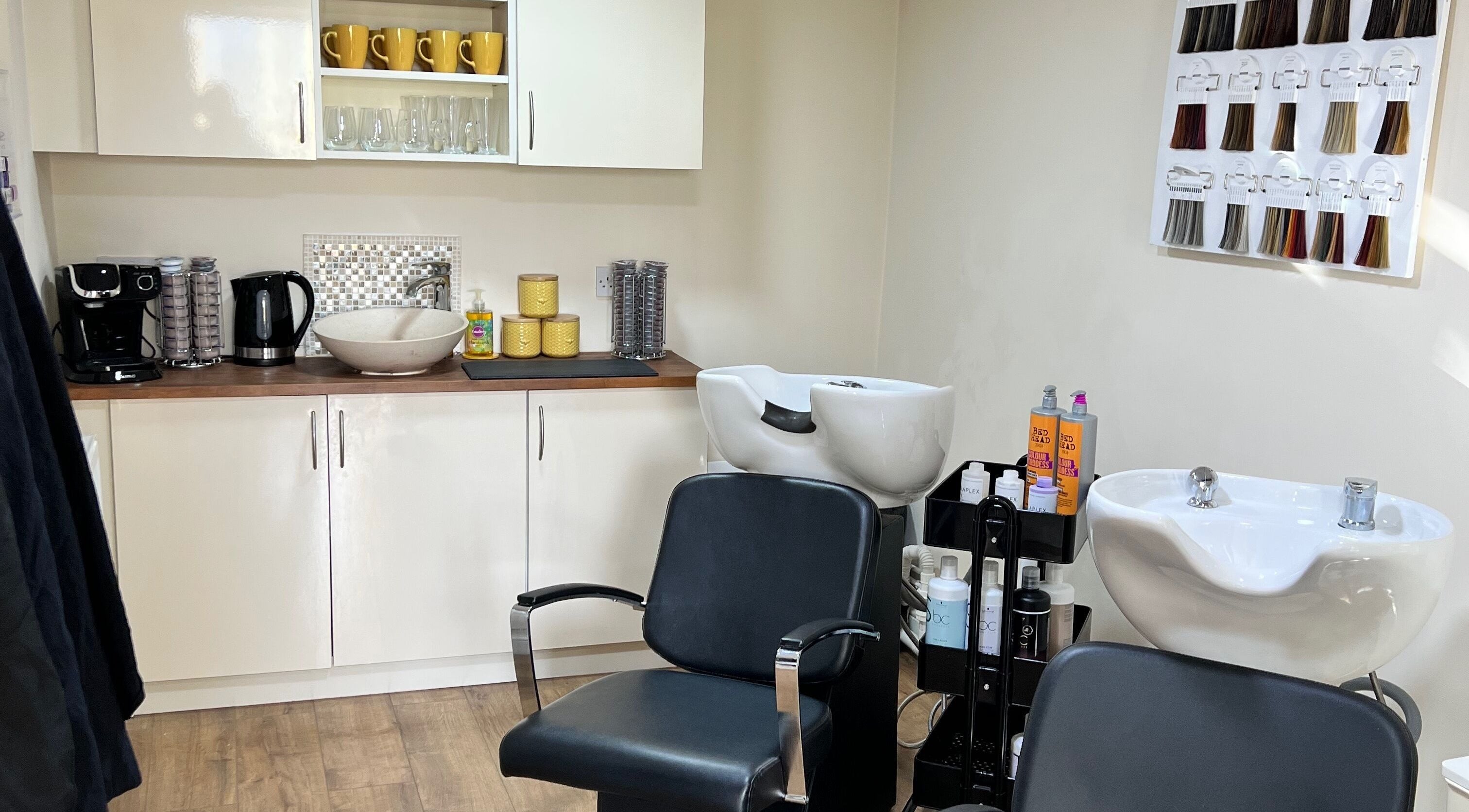 Interior of David Charles Hair, Health and Beauty Studio in Raunds, England, GB featuring sink and seating area.