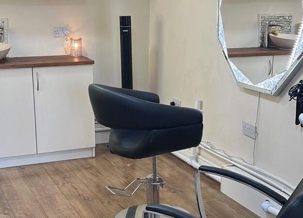 Modern styling chair and mirror at David Charles Hair, Health and Beauty Studio, Raunds, England, GB.