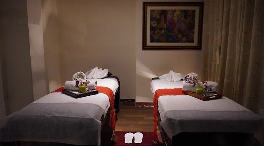Relaxing massage room at Body Raaga Wellness Spa - Jayanagar, Bengaluru, Karnataka, IN with twin beds and decor.