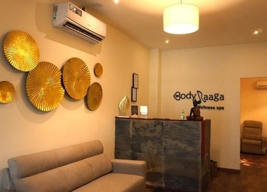 Elegant reception at Body Raaga Wellness Spa - Jp Nagar, Bengaluru, Karnataka, IN with golden wall decor.