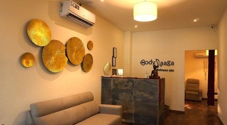 Elegant reception at Body Raaga Wellness Spa - Jp Nagar, Bengaluru, Karnataka, IN with golden wall decor.