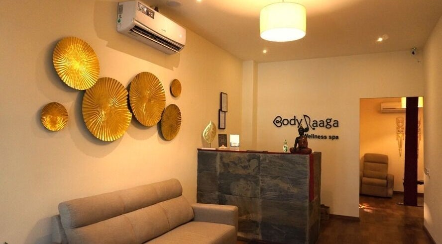 Elegant reception at Body Raaga Wellness Spa - Jp Nagar, Bengaluru, Karnataka, IN with golden wall decor.