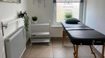 Relaxing treatment room at Zig-Zag Hair & Beauty in Normanton, England, GB featuring a massage table.